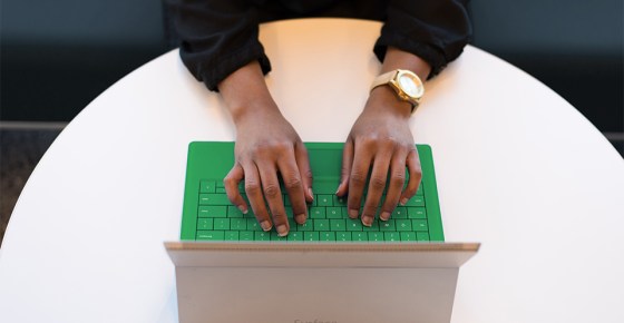 woman typing on a Microsoft surface computer