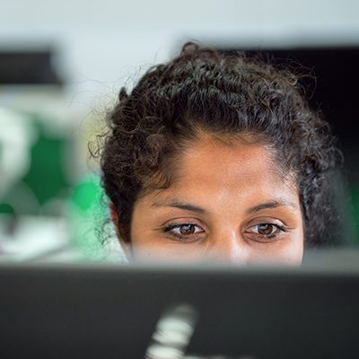 woman's eyes staring at computer screen