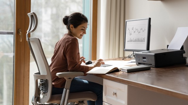 A woman working remotely from her home office